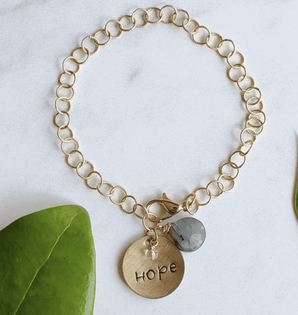 Gold bracelet with hope written on a medallion