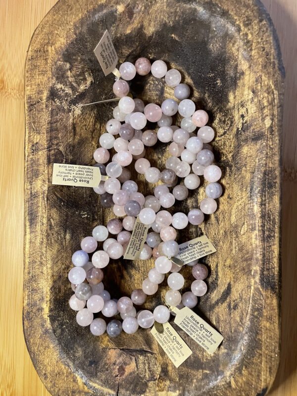 A bowl of rose quartz bracelet